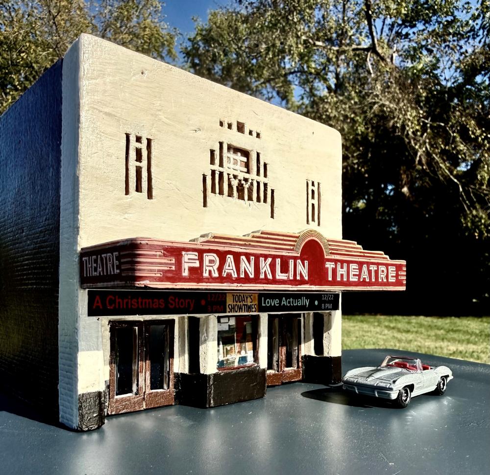 HO-scale Franklin Theatre miniature, angled view with silver convertible