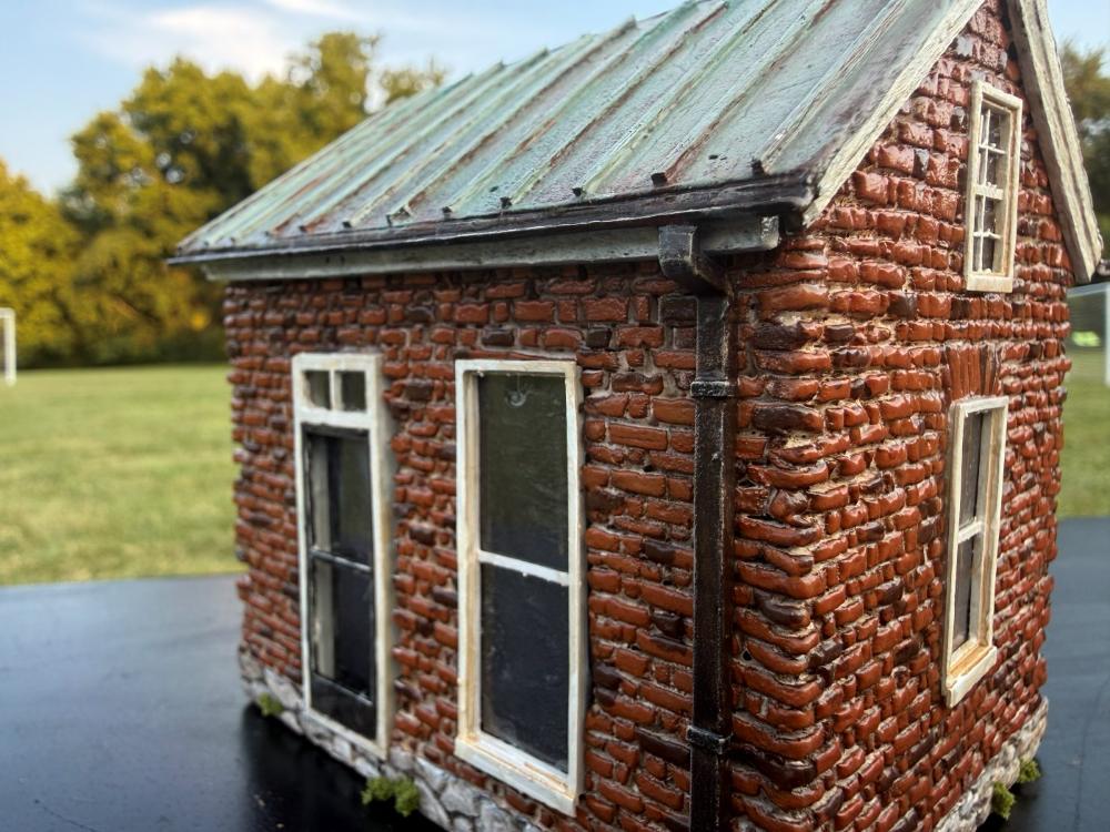 McPhail House miniature, corner view with hand-painted brick and downspout